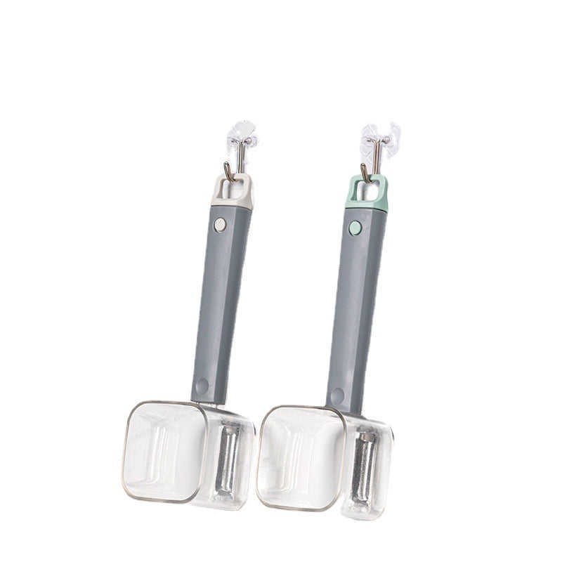 Two handheld stainless steel vegetable peelers with grey handles and clear protective covers