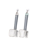 Two handheld stainless steel vegetable peelers with grey handles and clear protective covers