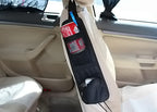 Car seat organizer attached to beige front seat with pockets holding a soda can and a blue pen inside a compact car interior
