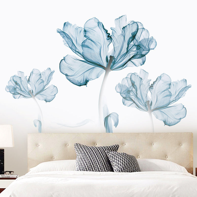 Modern bedroom with beige tufted headboard, white bedding, black patterned pillows, and large blue floral wall art