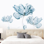 Modern bedroom with beige tufted headboard, white bedding, black patterned pillows, and large blue floral wall art