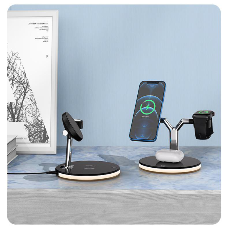 Dual wireless charging station on table with smartphone, smartwatch, and earbuds charging, blue wall background