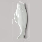 White ceramic fish-shaped spoon rest with detailed fins, measuring 26.2cm by 7.3cm by 9.5cm