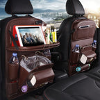 Brown leather car backseat organizer with tablet holder, cup holders, tissue box, and storage compartments