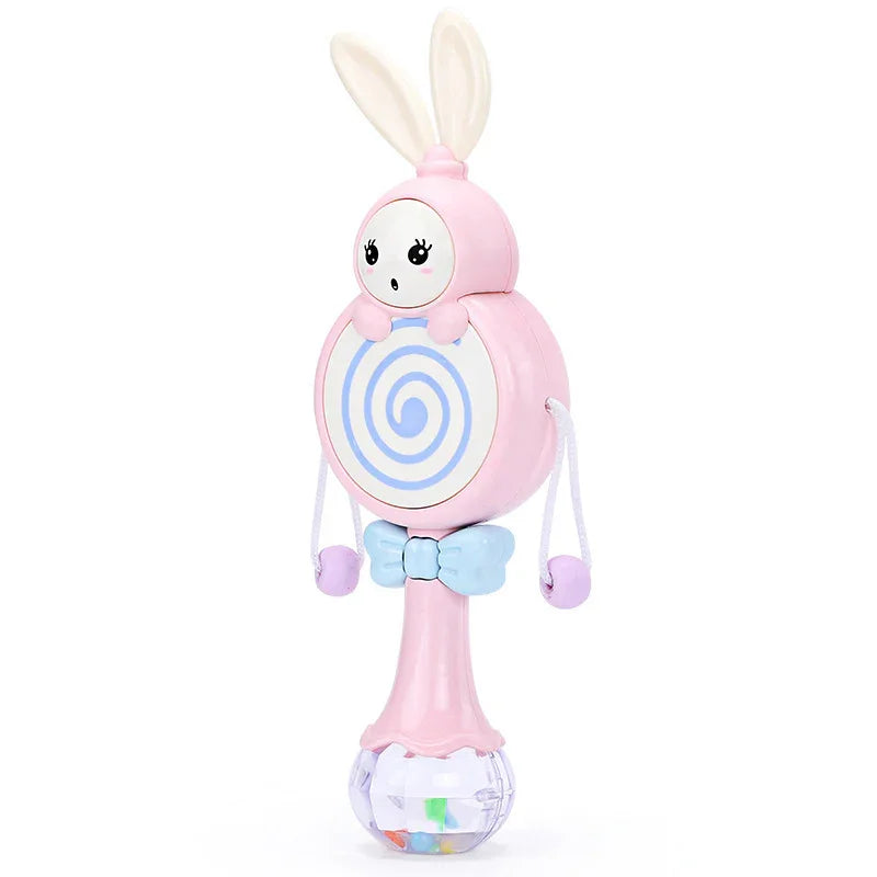 Pink bunny-shaped baby rattle toy with spiral design, blue bow tie, and dangling beads