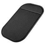 Black non-slip rubber dashboard mat with textured grip surface and raised edges