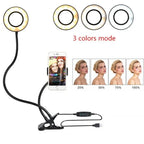 Clip-on LED ring light with flexible arm and phone holder, adjustable brightness and three color modes