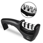 Black handheld kitchen knife sharpener with three slots and ergonomic handle on white background