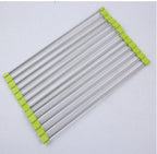 Stainless steel kitchen drying rack with green silicone edges on white background