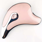 Pink and chrome dolphin-shaped modern wireless speaker with power button on white background