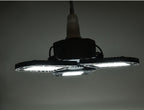 Modern black LED garage light with three bright adjustable panels mounted on ceiling