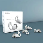 White iMeBoBo three-layer noise earplugs with ergonomic hooks and packaging on gray surface