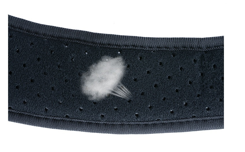 Close-up of black perforated fabric with white steam or vapor puffing out