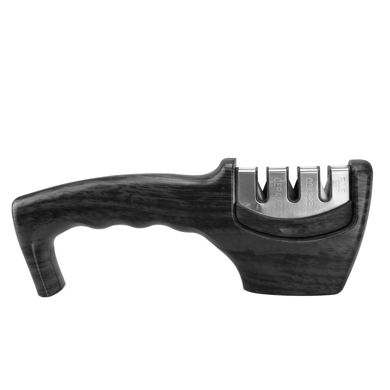 Handheld three-stage knife sharpener with black ergonomic handle and slots labeled ceramic, coarse, fine
