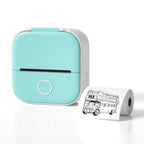 Compact turquoise portable thermal printer with printed paper showing a vintage double-decker bus illustration