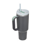 Gray insulated travel mug with handle, white lid and light blue straw isolated on white