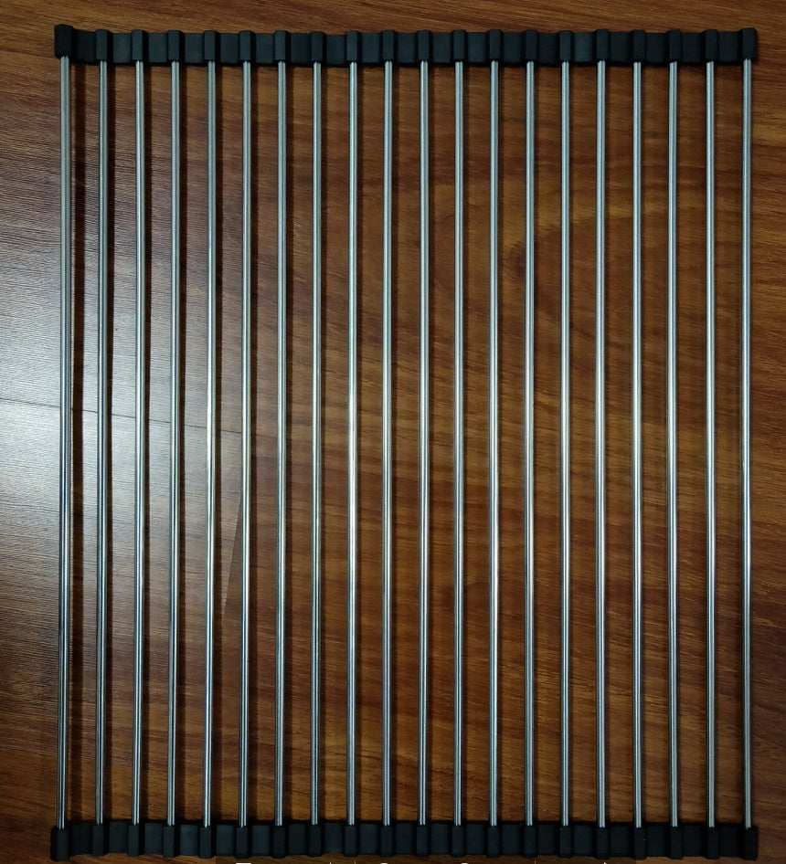 Roll-up stainless steel kitchen sink drying rack with black silicone edges on wooden surface