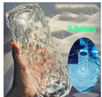 Hand holding a clear geometric patterned glass vase with light and shadow effects, featuring text '5 Colors' and inset image showing vase in blue lighting