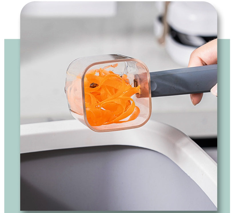 Hand holding a transparent vegetable peeler with orange carrot peels over a white and gray sink