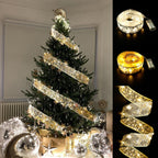 Decorated Christmas tree with gold star ribbon and fairy lights, surrounded by silver ornaments and gifts