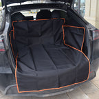 Black waterproof car trunk liner with orange trim protecting an open SUV cargo area
