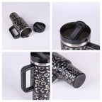 Black stainless steel travel mug with leopard print, black handle, and spill-proof lid