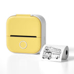 Compact yellow and white portable thermal printer with printed sketch of double-decker bus on paper roll